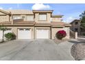 Condo building featuring attached garages, desert landscaping, and red tile roofing at 5450 E Mclellan Rd # 145, Mesa, AZ 85205