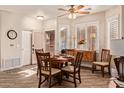 Bright dining area features a wooden table set for six, wood floors and plantation shutters at 5450 E Mclellan Rd # 150, Mesa, AZ 85205