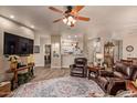 Cozy living room showcases hardwood floors, leather seating, and backyard views at 5450 E Mclellan Rd # 150, Mesa, AZ 85205