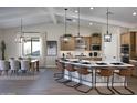 Bright, open kitchen featuring stainless steel appliances, a large island with seating, and stylish pendant lighting at 6094 N Sunrise Ln, Buckeye, AZ 85396