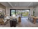 Inviting living room with a sliding glass door that opens to an outdoor dining and entertainment space at 6094 N Sunrise Ln, Buckeye, AZ 85396