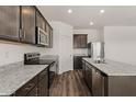Stylish kitchen has stainless appliances, granite countertops, and ample storage at 652 W Pintail Dr, Casa Grande, AZ 85122