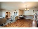 Spacious living room boasts hardwood floors, neutral paint, and access to kitchen and dining area at 6711 E Presidio Rd, Scottsdale, AZ 85254