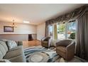 Cozy living room features ample natural light, hardwood floors, and comfortable seating area at 6711 E Presidio Rd, Scottsdale, AZ 85254
