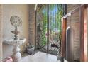 View of the decorative iron entry gate leading to a serene outdoor space with garden views at 7517 E Mariposa Grande Dr, Scottsdale, AZ 85255