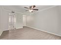 Open living room with wood-look flooring, neutral walls, and a ceiling fan at 8256 E Arabian Trl # 239, Scottsdale, AZ 85258