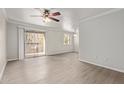 Living room with wood-look floors and sliding glass doors to a balcony at 8256 E Arabian Trl # 239, Scottsdale, AZ 85258