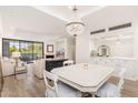 Elegant living and dining area with chandelier, fireplace, and a view to the outdoor patio at 902 W Glendale Ave # 215, Phoenix, AZ 85021
