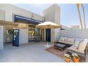 An expansive patio featuring comfortable lounge furniture under an umbrella for relaxing in the sun at 902 W Glendale Ave # 215, Phoenix, AZ 85021