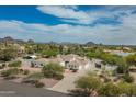 Expansive aerial view showcasing the desert property, surrounding mountains, and lush landscaping at 9053 N 123Rd St, Scottsdale, AZ 85259