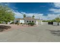 Spacious property featuring a long driveway, pristine landscaping, and a well-maintained exterior at 9053 N 123Rd St, Scottsdale, AZ 85259