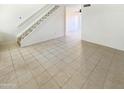 Open living space with tile flooring and a staircase leading to the upper level at 10101 N 91St Ave # 162, Peoria, AZ 85345