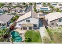 Aerial view showcasing a private pool, well-maintained lawn, and the surrounding neighborhood at 11317 W Cottonwood Ln, Avondale, AZ 85392