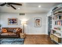 Comfortable living room showcasing a leather sofa, stylish rug, textured walls, and curated bookshelves at 1402 E Granada Rd, Phoenix, AZ 85006
