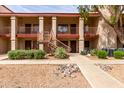 Attractive two-story condo exterior with desert landscaping and pedestrian access at 1440 N Idaho Rd # 2053, Apache Junction, AZ 85119