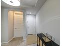 Bright entryway with hard surface floors and a white front door at 14413 W Dahlia Dr, Surprise, AZ 85379