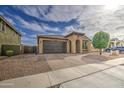 Inviting single-story residence boasting a two-car garage and attractive desert landscaping for minimal upkeep at 14413 W Dahlia Dr, Surprise, AZ 85379