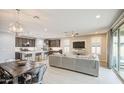 Open-concept living room and kitchen with modern decor and ample natural light at 14413 W Dahlia Dr, Surprise, AZ 85379