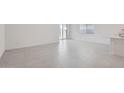 Open-concept living area featuring bright, neutral tones, tile flooring, and plenty of natural light at 15585 W Williams St, Goodyear, AZ 85338