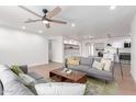 Comfortable living room featuring contemporary furnishings, a ceiling fan, and an open floor plan at 1649 W Carmel Ave, Mesa, AZ 85202