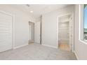 Neutral bedroom with carpet, adjacent doors leading to the bathroom and closet at 18716 N 269Th Ln, Buckeye, AZ 85396
