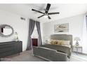 Relaxing bedroom with a ceiling fan, dresser, mirror and ensuite bathroom access at 1880 E Morten Ave # 242, Phoenix, AZ 85020