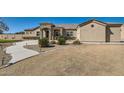 Stunning front exterior with well maintained desert landscaping and neutral colored stucco at 19535 E Via De Olivos Rd, Queen Creek, AZ 85142