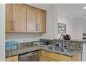 Kitchen featuring stainless steel dishwasher, granite countertops and light wood cabinets at 2025 E Campbell Ave # 114, Phoenix, AZ 85016