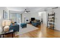 Bright living room with hardwood floors and contemporary furnishings including blue sofa and chairs at 2025 E Campbell Ave # 114, Phoenix, AZ 85016