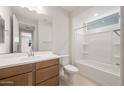 This is a view of the bathroom with a single sink vanity and a shower and bath combination tub at 21296 N 270Th Dr, Buckeye, AZ 85396