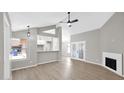 Cozy living room with a fireplace, modern ceiling fan, and lots of natural light at 2234 W Mohawk Ln, Phoenix, AZ 85027