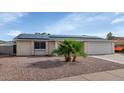 Charming single-story home with desert landscaping, solar panels and a two-car garage at 2262 E Javelina Ave, Mesa, AZ 85204