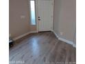 Bright entryway features a white door, a slim window, and light-colored wood-look flooring at 2729 E Carol Ave, Mesa, AZ 85204