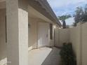 View of the front entry with its painted white door, and small garden in front at 2729 E Carol Ave, Mesa, AZ 85204