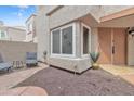 Inviting front entrance with a small private patio area, featuring updated desert-style landscaping at 2834 S Extension Rd # 1079, Mesa, AZ 85210