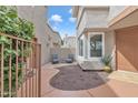 Private patio area with seating, surrounded by mature plants and desert landscaping at 2834 S Extension Rd # 1079, Mesa, AZ 85210