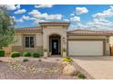 Charming single-story home featuring a beautiful desert landscape, a covered entryway, and a two-car garage at 3945 E Cherry Hills Dr, Chandler, AZ 85249