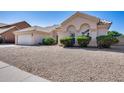Attractive single-story home featuring a two-car garage and low maintenance gravel landscaping at 4001 E Rosemonte Dr, Phoenix, AZ 85050