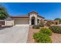 Inviting single-story home with desert landscaping, a two-car garage, and a well-maintained lawn at 4094 E Los Altos Dr, Gilbert, AZ 85297