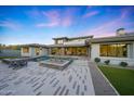Luxury home featuring an inviting outdoor space with a pool and desert landscaping at 4098 N Golf Dr, Buckeye, AZ 85396