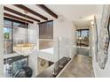 Bright hallway with soaring ceilings, glass railing, modern lighting, and natural light at 7401 N Scottsdale Rd # 24, Paradise Valley, AZ 85253