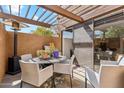 Cozy patio with chandelier, table, seating, grill, heater, and sliding door entry at 7401 N Scottsdale Rd # 24, Paradise Valley, AZ 85253