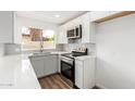 Bright kitchen featuring stainless steel appliances, white cabinets, and a window view at 747 W Rice Dr, Tempe, AZ 85283