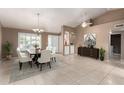 Elegant dining room featuring a chandelier, stylish chairs, and a decorative rug at 8011 E Milagro Ave, Mesa, AZ 85209