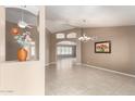 Spacious living room featuring neutral walls, tile flooring, and decorative art niches at 8011 E Milagro Ave, Mesa, AZ 85209