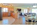 Open-concept kitchen with light wood cabinets, a spacious island with seating, and views into the adjacent living area at 8020 E Keats Ave # 279, Mesa, AZ 85209