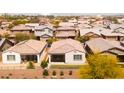 An aerial view shows well-maintained homes, tile roofs, and desert landscaping in this desirable neighborhood at 9229 W Willow Bend Ln, Phoenix, AZ 85037