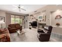 Cozy living room featuring a built-in entertainment center, a ceiling fan, and sliding glass doors to a patio at 9253 N Firebrick Dr # 206, Fountain Hills, AZ 85268