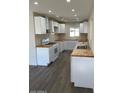 Modern kitchen featuring white cabinets, wooden countertops, and stainless steel appliances at 120 N Jackson St, Chandler, AZ 85225