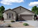 A beautiful single-story home with a two-car garage, gravel landscaping, and a well-kept lawn at 13193 E Verbina Ln, Florence, AZ 85132
